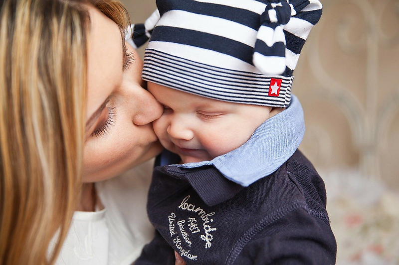 mum kissing a baby