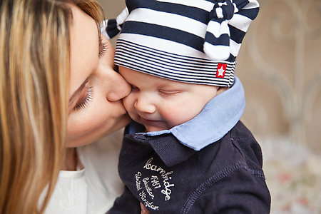 mum kissing a baby